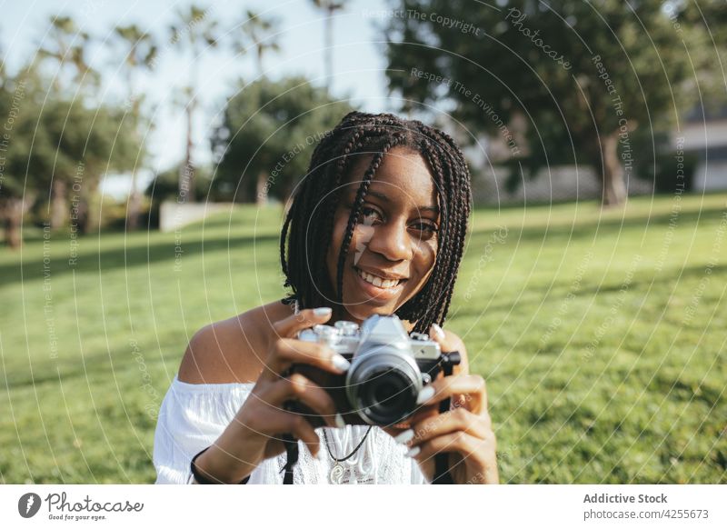 Black woman taking photo on camera photographer photo camera take photo capture memory moment lawn park photography female hobby african american black summer