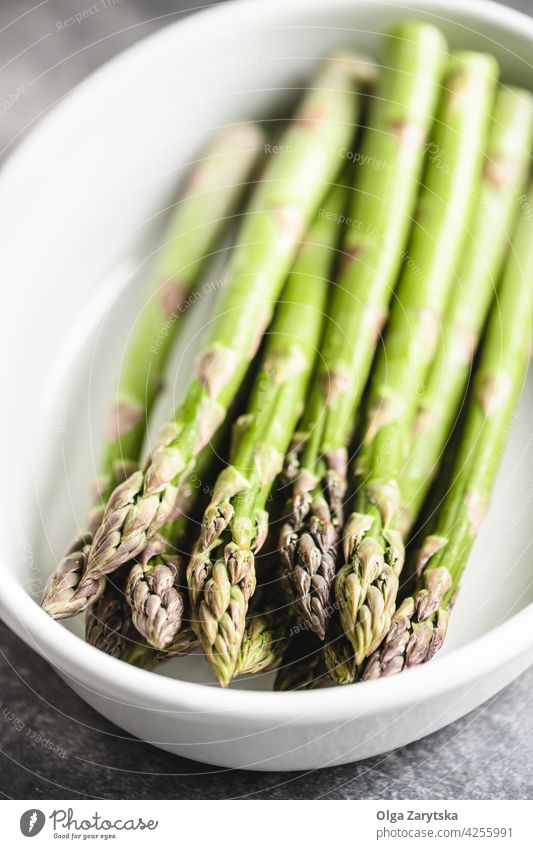 Asparagus in white ceramic baking dish. asparagus fresh selective focus close up healthy food vegetable vegetarian raw steam green