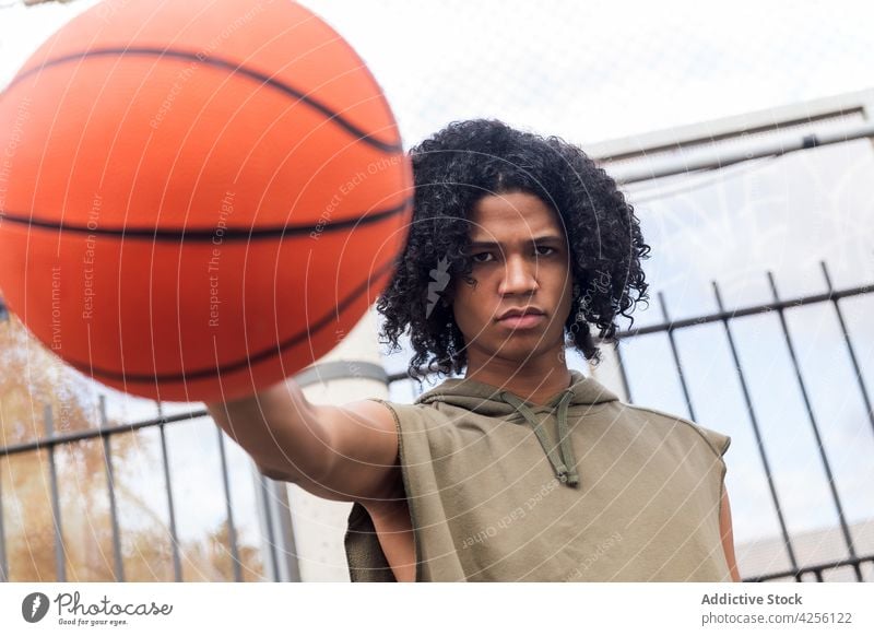 Black basketball player with ball in park man throw sport game training hobby practice male activity sports ground athlete court serious casual youth hairstyle