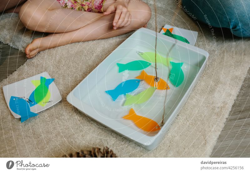 Homemade fishing game made with sticks and acetate homemade diy family games string magnet clip water serving platter unrecognizable child fun easy to do people