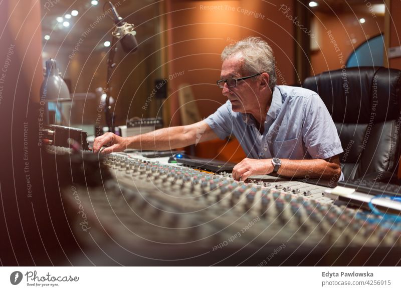Mature man at mixing desk in a recording studio senior men male people lifestyle enjoying real people casual adult one person Caucasian aged mature elderly