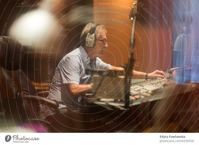 Mature man at mixing desk in a recording studio senior men male people lifestyle enjoying real people casual adult one person Caucasian aged mature elderly