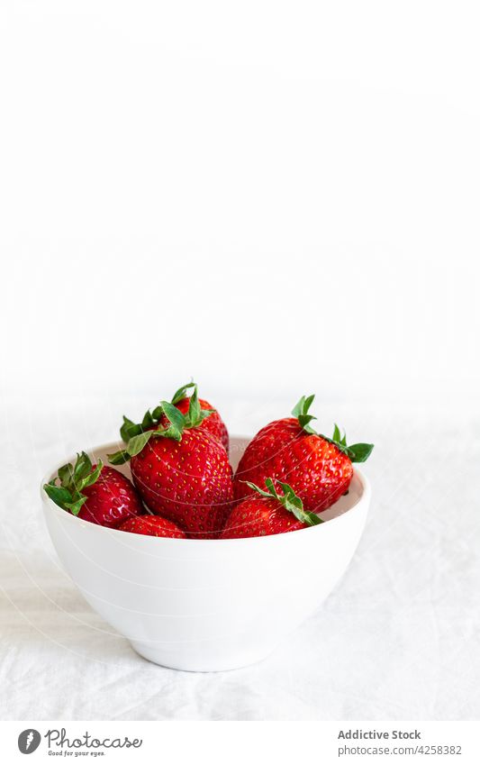 Delicious ripe strawberries in bowl on fabric strawberry vitamin delicious fresh natural juicy bright scent textile round shape sepal colorful tasty aroma cloth
