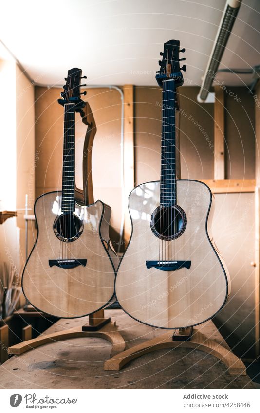 Acoustic guitars against manual instruments in workshop musical handmade classical acoustic tool professional small business woodwork file template storage