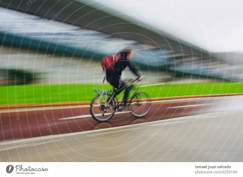 cyclist on the street in Bilbao city spain biker bicycle transportation cycling biking exercise lifestyle ride speed fast blur blurred motion movement defocused