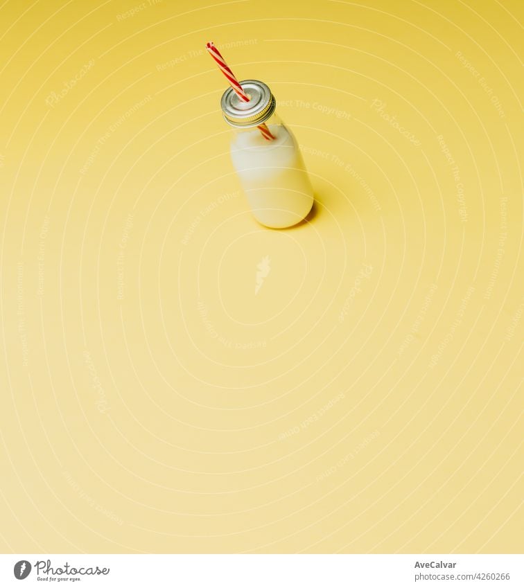 Super minimalist mockup of a milkshake over a pastel yellow background with copy space creativity horizontal icon set no people photography sparse usa person