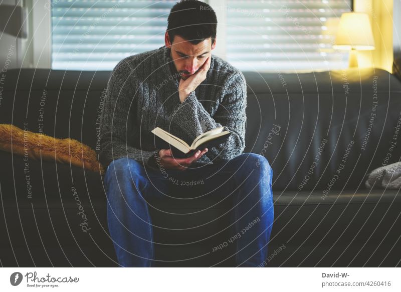 Man engrossed in a book Book Reading Sofa hollowed Education Novel Reader Literature Study concentrated Know at home Sit
