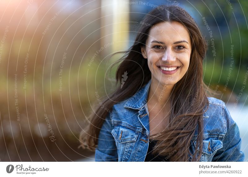 Portrait of young woman in the city urban street active people young adult casual attractive female happy Caucasian enjoying one person beautiful positivity