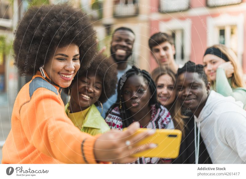 Happy multiethnic friends taking selfie on smartphone in town memory moment smile street using gadget women device cellphone self portrait content glad