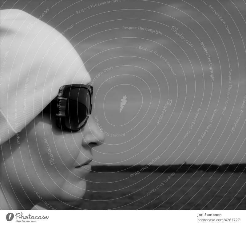 Profile of a woman with sunglasses and a beanie. Woman Silhouette Face Nose Mouth Lips Sunglasses Human being Feminine Adults 1 Head Day Skin Exterior shot