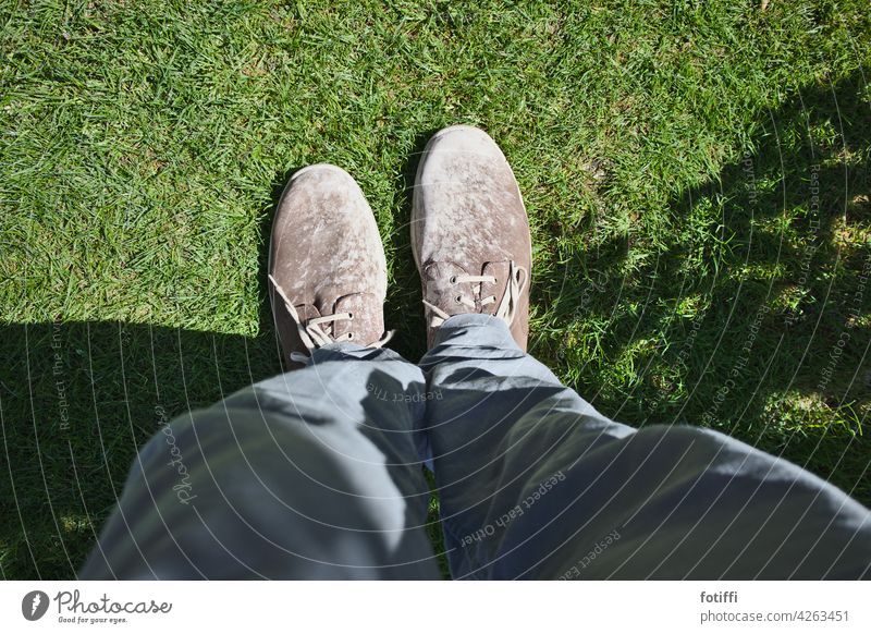 52 | big feet in brown, loamy shoes Feet Footwear Loam smudged bots Greasers Human being Legs Lawn Grass Bird's-eye view Shadow Exterior shot Meadow Green Light