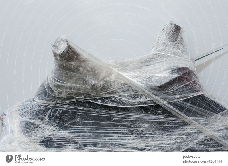 Motorcycle wrapped in cling film Detail Packing film Structures and shapes Protection transparent Abstract Handlebars Neutral Background White Unrecognizable