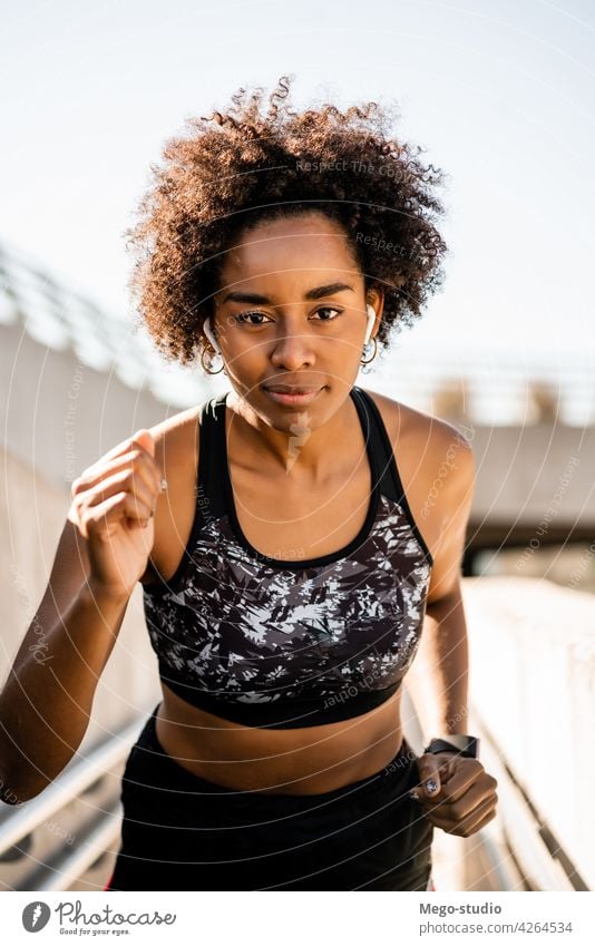 Afro athlete woman running outdoors. sport exercise training runner background people care leisure body portrait sports action motion cardio exercising