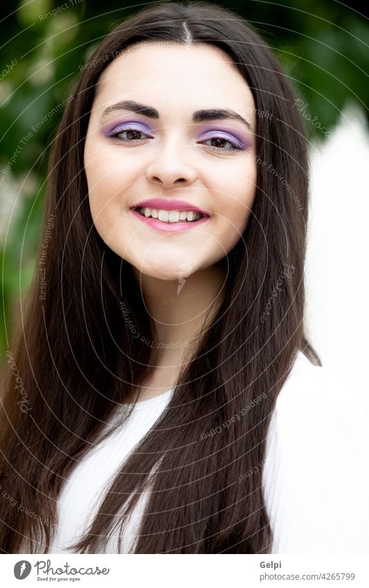 Cute young woman with  purple eyeshadow teenage person outside face hair girl beautiful park model pretty nature make-up female happy portrait beauty lifestyle