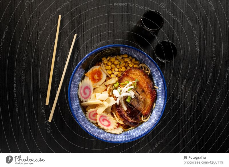 Japanese miso ramen soup on dark background viewed from above. Japanese noodles. japanese onion concrete food asian soy sauce bowl chinese meat cookery plate