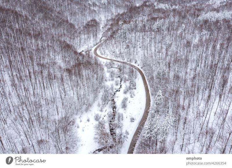 Curvy Winding Road and Mountain Stream winding road curvy stream meandering brook curved parallel aerial view forest drone tree landscape water cold frozen