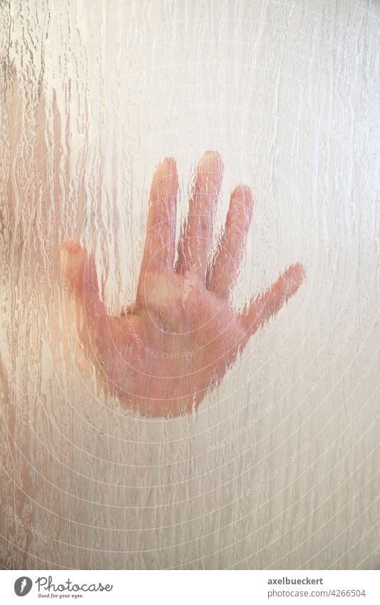 female hand behind frosted glass shower screen shower partition woman window pane sex crime sexual assault mystery thriller horror help bathroom girl palm