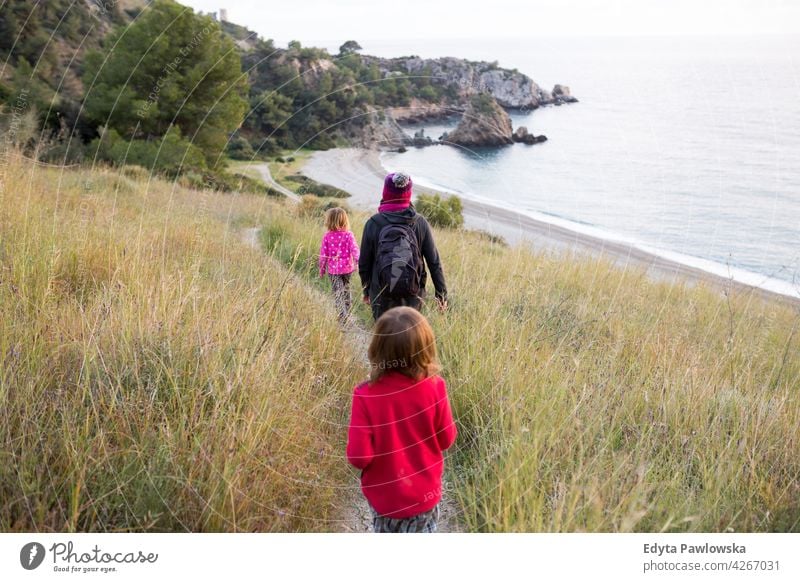 Family walking on the Andalusian beach in winter, Cala del Cañuelo, Spain girl woman young people beautiful three people family kids mother children lifestyle