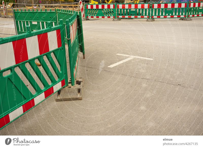 A construction site is secured by green plastic barrier beacons / lane narrowing / construction fence Construction site Barrier beacons Shut-off technology