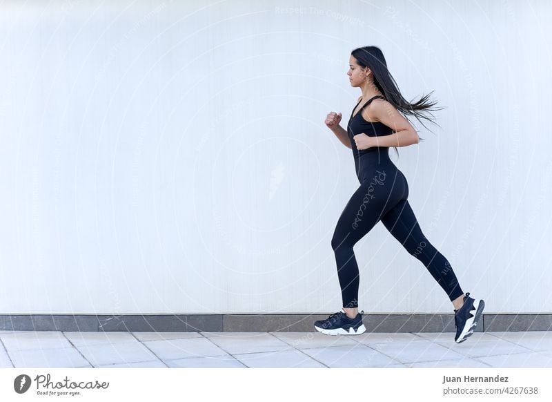 Young woman with fit body running in sportswear young jumping female model exercising athlete exercise fitness training runner horizontal athletic speed