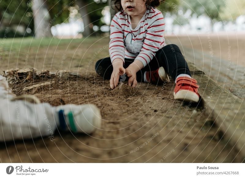 Child playing in the park soil Mud Dirty Playing childhood 1 - 3 years Infancy Human being Colour photo Toddler Exterior shot Multicoloured Day Happiness