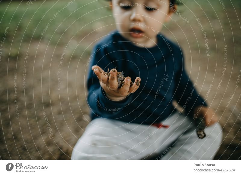 Child playing outdoors with soil Mud Dirty Curiosity explore Authentic Playing Nature Colour photo Caucasian Lifestyle Happy Infancy Joy 1 - 3 years Happiness