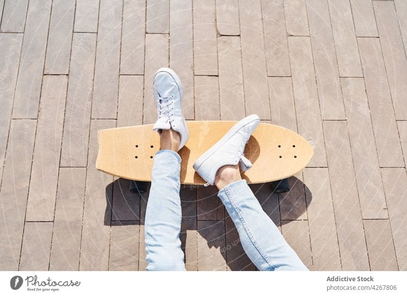 Male skateboarder in park in sunlight man chill hobby leisure free time sport pastime urban cool male relax activity sneakers casual footwear jeans street rest