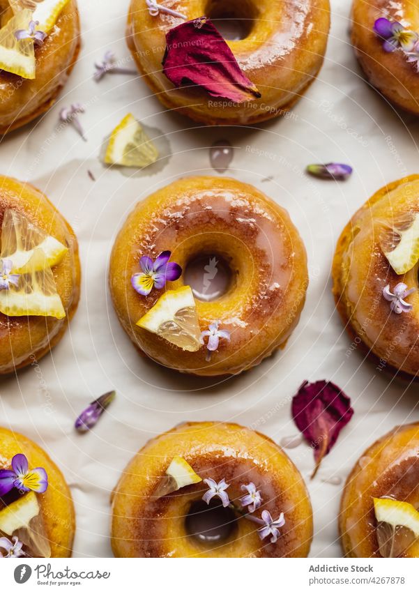 Delicious donuts with fresh lemon slices on rack doughnut lavender pastry treat sweet aroma delicious deep fried cooling rack row similar organic flower natural