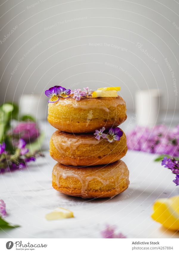 Delicious doughnuts with lemon slices and lavender flowers glaze pastry sweet treat yummy pile deep fried donut natural aroma delicious organic fresh plant