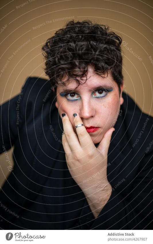 Eccentric man with bright makeup and manicure androgynous eccentric feminine unusual unique style appearance male cosmetic alternative extraordinary beauty