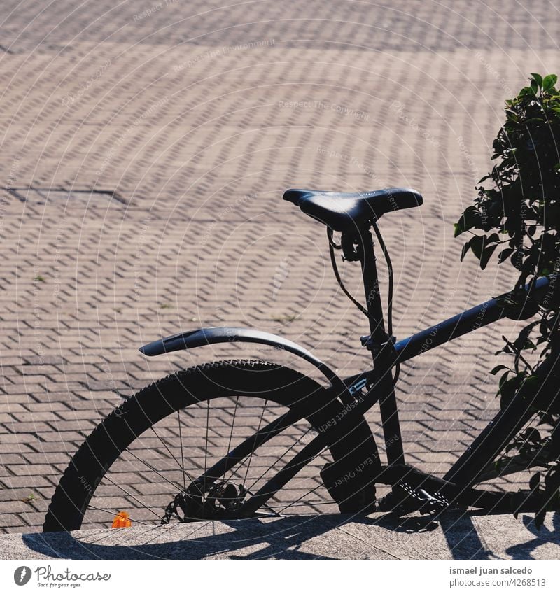 black bicycle on the street mode of transportation bike cycling biking seat wheel handlebar object hobby lifestyle outdoors urban healthy leisure road
