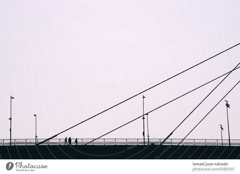 people silhouette on the bridge in Bilbao city Spain person pedestrian shadow street outdoors minimal city life lifestyle visit visiting walking tourist tourism