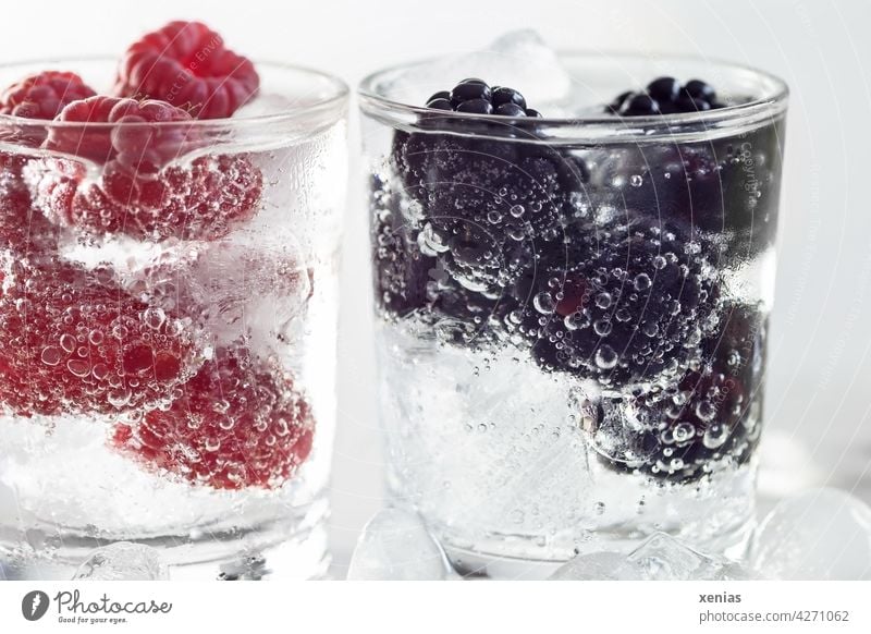 Two glasses of fresh iced vitamin water with raspberries and blackberries Beverage Water Cold drink Glass Drinking water Raspberry Blackberry Berries
