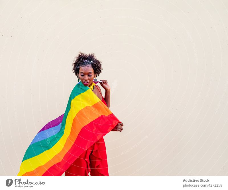 Stylish black woman with LGBTQ flag on light background lgbtq fashion style pride equality tolerance individuality rainbow ornament celebrate festive stylish