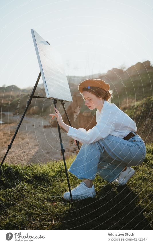 Young lady assembling easel on coast before painting sea woman assemble beach ocean painter inspiration style nature seashore sand traveler female young casual