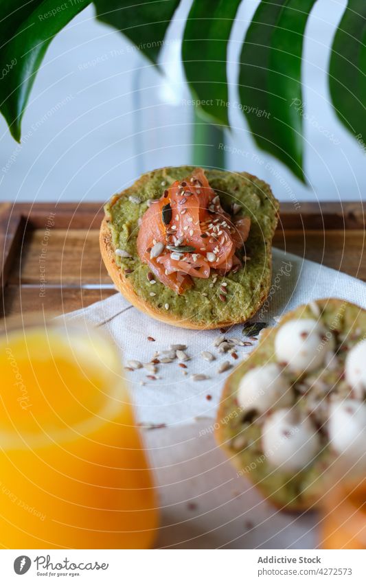 Delicious avocado toasts with salmon and mozzarella served with cold drinks during breakfast juice tea healthy food meal tasty beverage delicious cheese snack