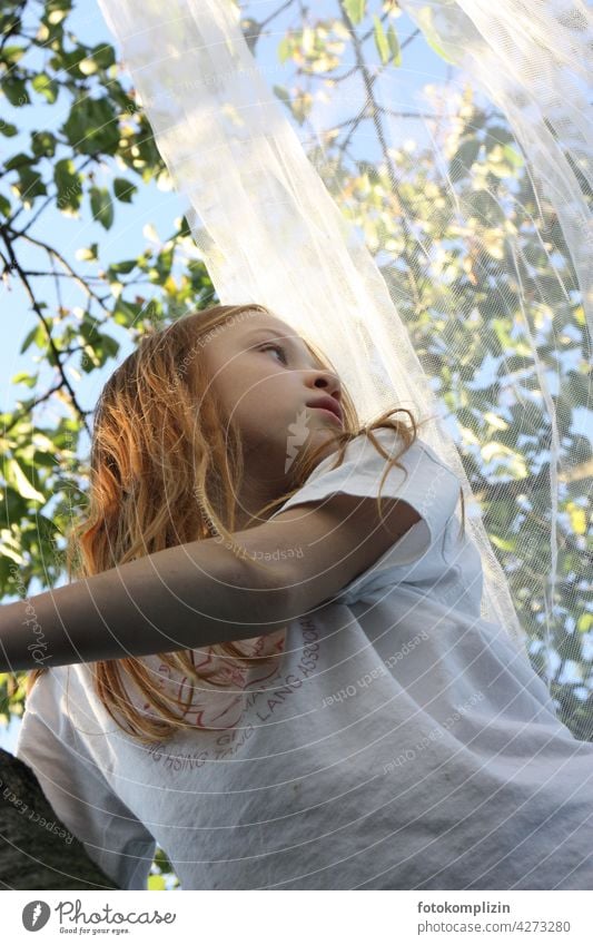 redhead girl with fly net in tree Girl Child Long-haired Red-haired Tree Mosquito net romantic Youth (Young adults) Human being look Nature Experiencing nature