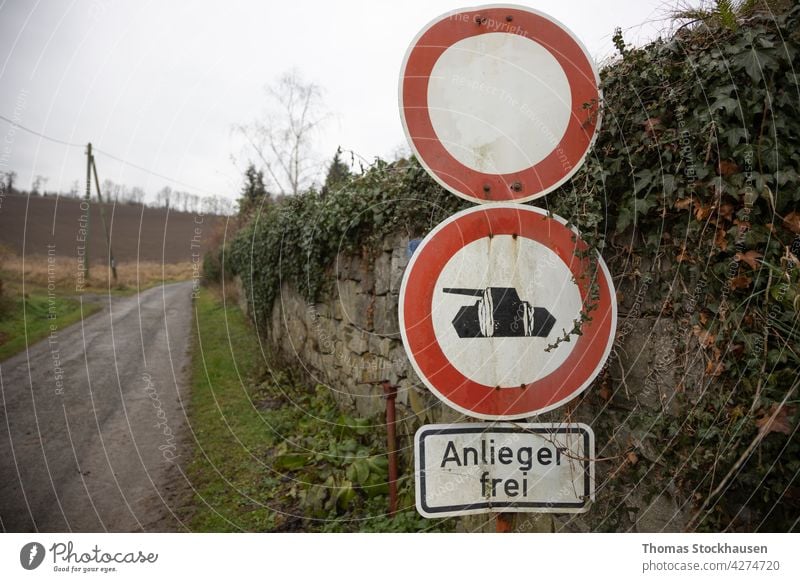 German sign no passing, no passing for tanks, German words that residents are allowed to enter, grafel path and stone wall in rural area circle cloudy country