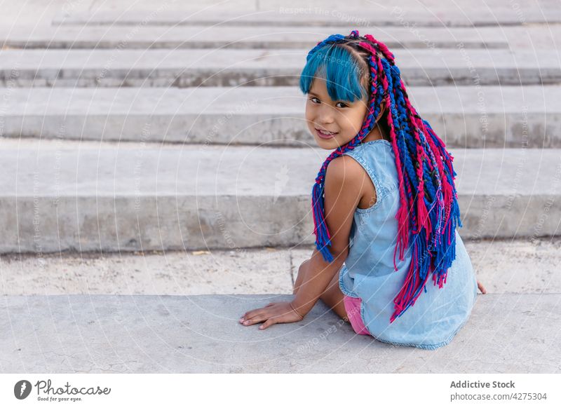 Mexican girl resting on stairs outdoors dreamy childhood lifestyle braid charming staircase smile admire friendly weekend rough contemplative cheerful sit