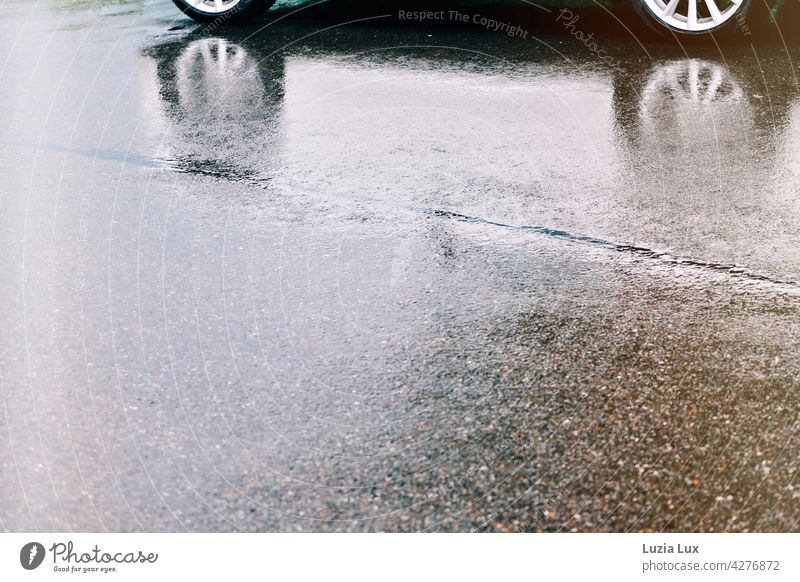 Summer rain, aluminium rims reflected in the wetness on the road surface Rain car reflection summer rain Reflection Wet Water Light splendour Glittering Street