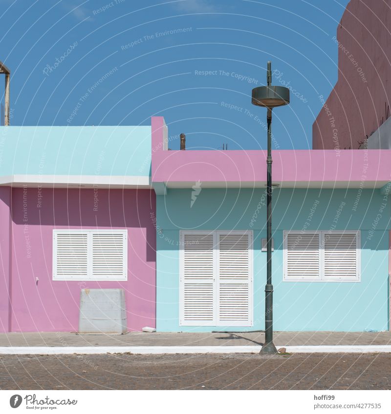 turquoise, pink, white, blue - house facade with street lighting and cloudless sky variegated Turquoise White Blue Facade Lantern Street lighting Sunlight