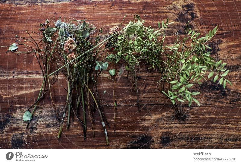 Dried flowers and leaves on wooden table Wood Wooden table Table Rustic Colour photo Brown Deserted Interior shot Shriveled Dry withered dried leaves Plant