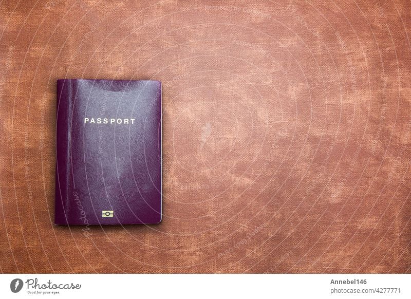 top view image of blank Passport on brown leather background texture with copy space, travel,tourist,document,indentification concept modern design cover