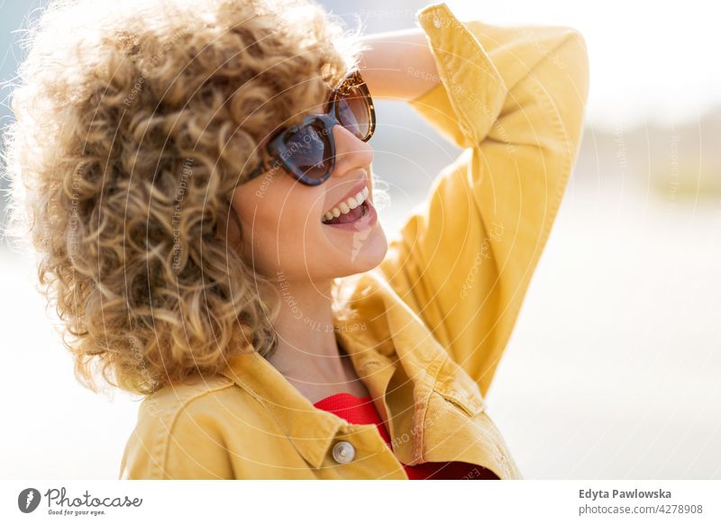 Portrait of young woman in sunglasses millennials urban street city stylish people young adult casual attractive female smiling happy Caucasian toothy enjoying