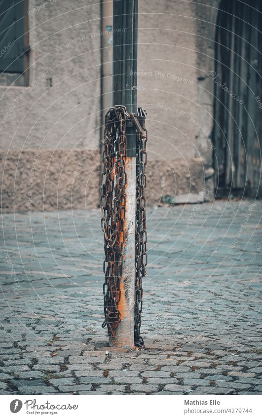 Iron chain on a post Structures and shapes Town Stone Lanes & trails Pavement Deserted Exterior shot Paving stone Cobblestones Traffic infrastructure Street