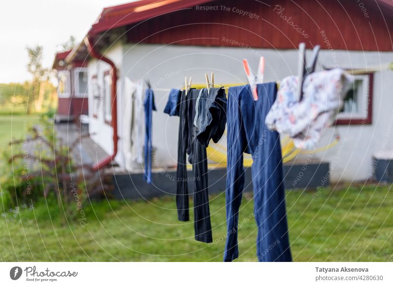 Drying clothes on rope at country backyard laundry clean clothespin summer wash air outdoor textile home eco outside building housework grass fresh green hang