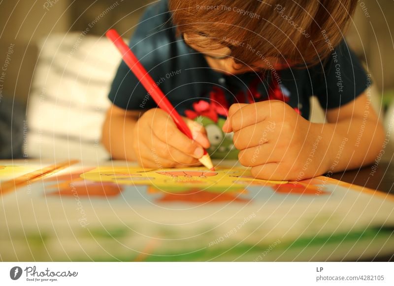 child wearing glasses and writing while being really concentrated Upper body Portrait photograph Pattern Talented Draw Drawing utensils Adventure