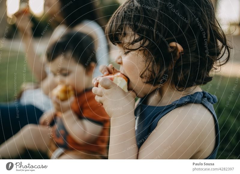Child eating applecgil Caucasian Summer Snack Eating Apple Day Healthy Eating Fruit Nutrition Food Colour photo Exterior shot Delicious Organic produce Fresh