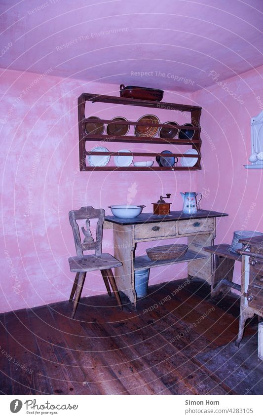 Old kitchen Kitchen Open-air museum wooden floor Coffee grinder Edge of a plate Pink Wooden chair Former sideboard interior decoration Past Nostalgia
