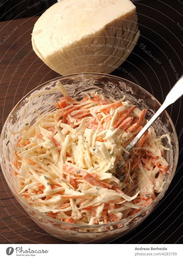 Traditional white cabbage salad with carrots ,chives, natural yogurt and vegan mayonnaise. Everything in organic quality ! healthy food glass bowl prepared